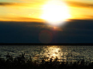 Dramatic sunset on river with light leak background