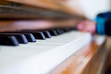 close-up piano keyboard with pianist hands