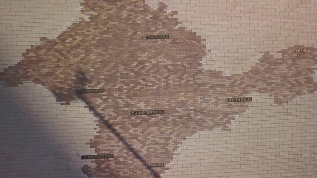 mosaic with map of Crimea on square in modern city in sunny day, aerial view