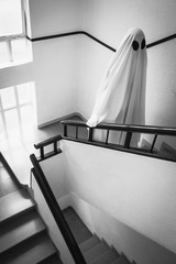 Ghost covered with a white ghost sheet on the stairs of an abandoned psychiatric hospital....
