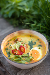 Spicy Coconut Noodle Soup with Fish, Egg and Vegetables. Laksa, Local Malaysian Dish.