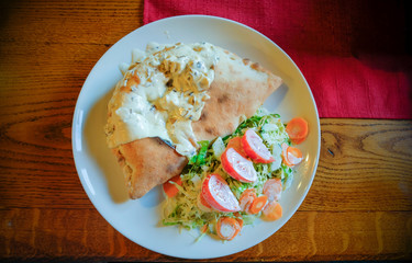 cake filled with veal, mushrooms, mushrooms, covered with milk sauce decoration cabbage, carrots and tomatoes