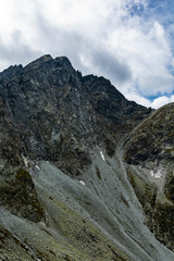 Rocky wall of the Tatra peak (Vysoka, Wysoka) seen from the slope in the valley.