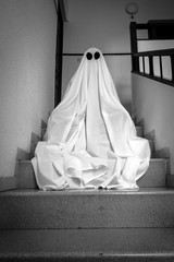Ghost covered with a white ghost sheet on the stairs of an abandoned psychiatric hospital....