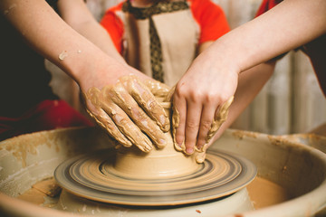 Fototapeta na wymiar Children's hands make a mold of clay. Pottery