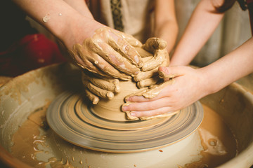 Children's hands make a mold of clay. Pottery