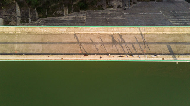 Aerial view of people shadows at Boadella i les Escaules water dam, Spain.