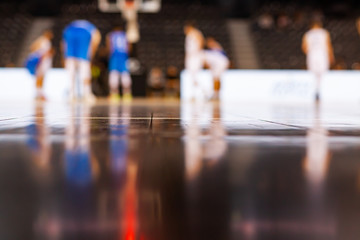blurred background of basketball players on court during game - very shallow depht of field