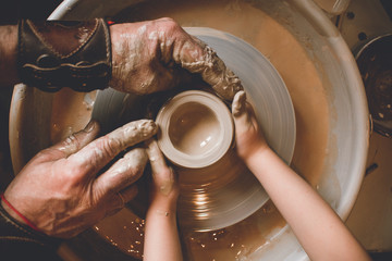Children's hands make a mold of clay. Pottery