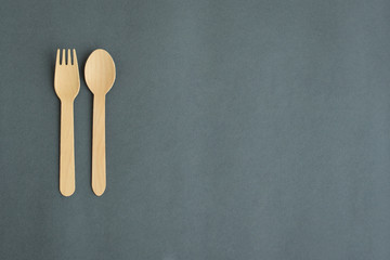 fork and spoon on gray paper background