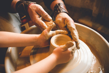 Children's hands make a mold of clay. Pottery