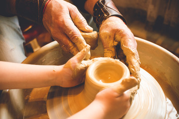 Children's hands make a mold of clay. Pottery
