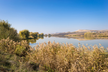 Beautiful landscape scenery of lakeshore and hills under a blue sky