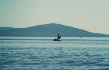 A girl boating in a boat on the White Sea, in summer. t. Kola Peninsula, Kandalaksha.