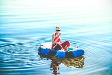 Fototapeta na wymiar A girl boating in a boat on the White Sea, in summer. t. Kola Peninsula, Kandalaksha.