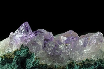 Macro close-up of an amethyst mineral crystal cluster.