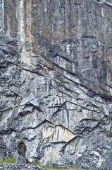 wall of dark rocks cut in a quarry