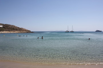 Fototapeta na wymiar Aegean sea: sand, water, ripples, reflections, waves and lighthouses