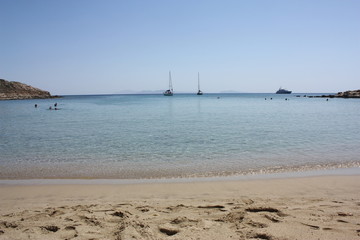 Fototapeta na wymiar Aegean sea: sand, water, ripples, reflections, waves and lighthouses