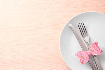 White plate with fork and knife on table