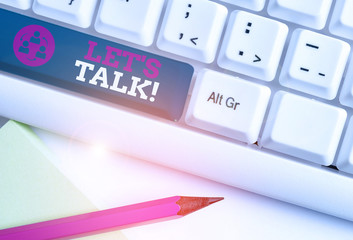 Conceptual hand writing showing Let S Is Talk. Concept meaning suggesting in the beginning of a conversation on the topic White pc keyboard with note paper above the white background