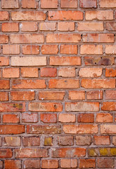 Brick wall texture, close up. Background with brickwork. The reddish surface of the building with grunge effect. Abstract wallpaper, portrait orientation. 