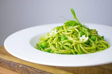 Food photography of spaghetti with a bright green ramp or wild garlic pesto