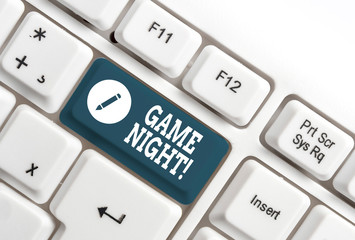 Conceptual hand writing showing Game Night. Concept meaning usually its called on adult play dates like poker with friends White pc keyboard with note paper above the white background