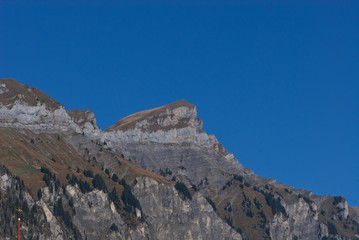 rock peaks in Alps against blue sky in autumn