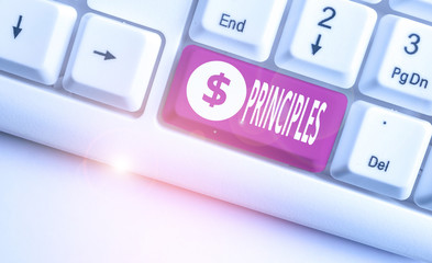 Conceptual hand writing showing Principles. Concept meaning fundamental truth that serves as the base for a system of belief White pc keyboard with note paper above the white background