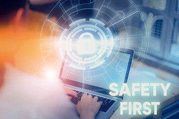 Conceptual hand writing showing Safety First. Concept meaning used to say that the most important thing is to be safe Picture photo network scheme with modern smart device