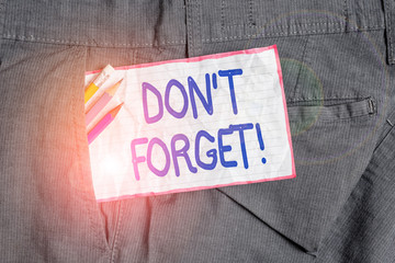 Text sign showing Don T Forget. Business photo text used to remind someone about important fact or detail Writing equipment and white note paper inside pocket of man work trousers