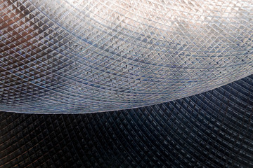 Close-up of industrial gray stainless steel flat part in partial focus after industrial CNC routing...