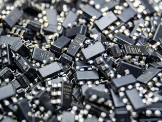 Abstract close-up of scattered surface mount chip computer semiconductor components