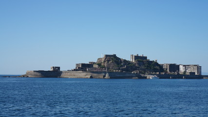 Obraz premium Gunkanjima is an abandoned city of a coal miners on the Hashima island in Japan. Panoramic view.
