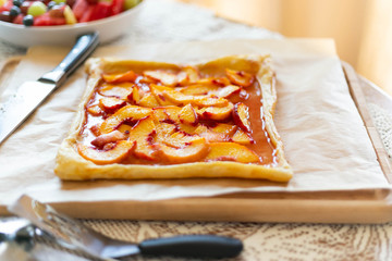 Rustic square peach galette on table