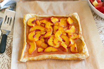 Rustic square peach galette on table