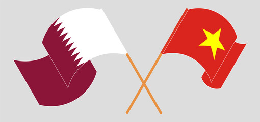 Crossed and waving flags of Vietnam and Qatar