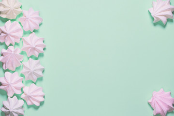 Small  meringues on colorful background. Festive and party concept. Minimal style. Flat lay. Top view