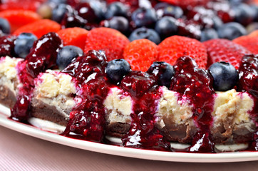 Detail of tart with fresh strawberries, blueberries and cherry jam.