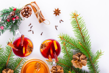 Mulled wine in glass mug with spices. Glasses of mulled wine with cinnamon, anise and fir tree...