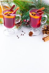 Mulled wine in glass mug with spices. Glasses of mulled wine with cinnamon, anise and fir tree branches. Winter Christmas drink. Top view. Flat lay