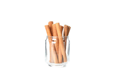 Cinnamon sticks in glass jar isolated on white background