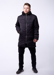 Fototapeta premium A man stand up wearing black jacket isolated white at the studio.