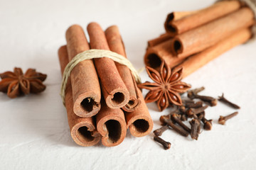 Cinnamon sticks and anise on white background, space for text