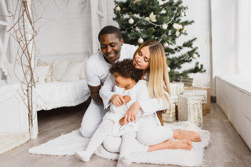 happy multiracial family with gifts at Christmas