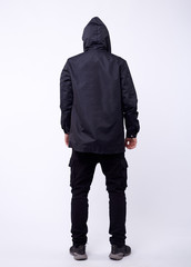 A man stand up wearing black jacket isolated white at the studio.