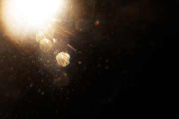 Lens Flare. Light over black background. Easy to add overlay or screen filter over photos. Abstract...