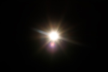 Fototapeta na wymiar Lens Flare. Light over black background. Easy to add overlay or screen filter over photos. Abstract sun burst with digital lens flare background. Gleams rounded and hexagonal shapes, rainbow halo.