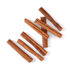 Cinnamon sticks isolated over white background closeup. Canella spice. Aromatic condiment background. Flat lay, top view..